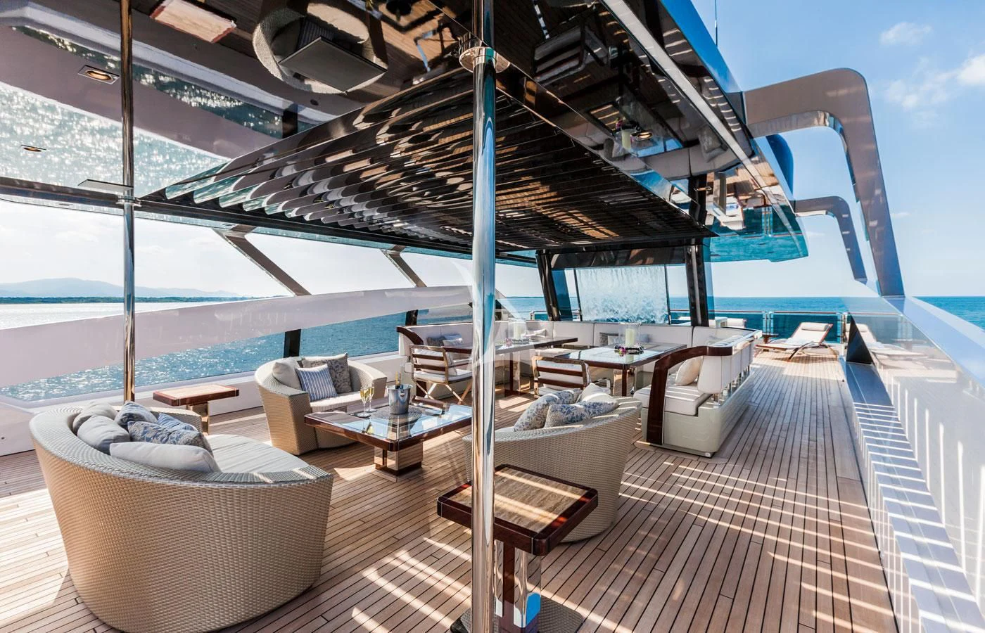 a deck with a lounge chair and a large body of water aboard PARILLION Yacht for Sale