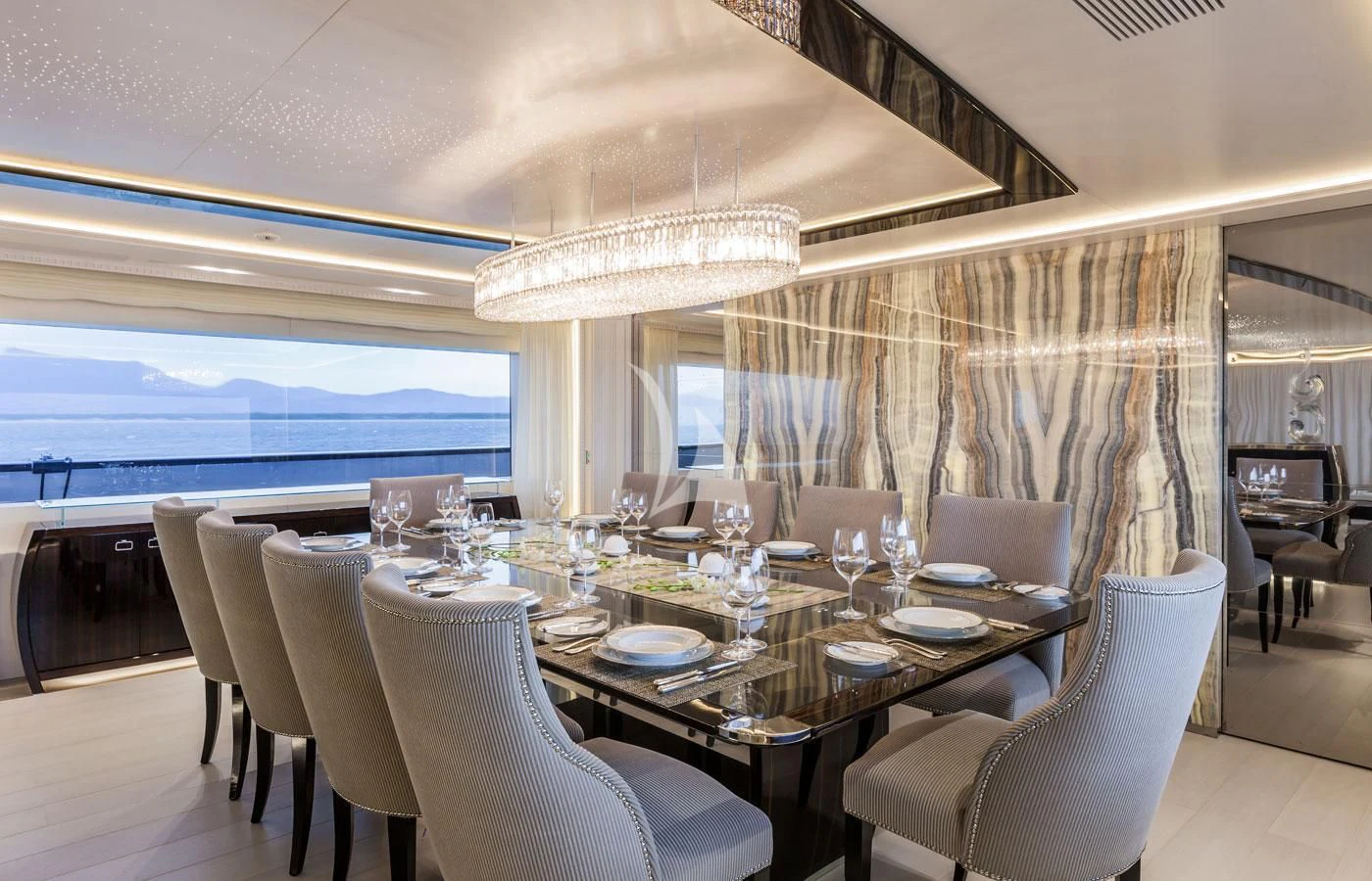 a large dining room with a large table and chairs aboard PARILLION Yacht for Sale
