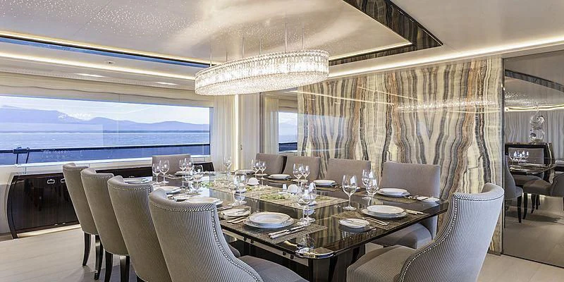 a large dining room with a large chandelier aboard PARILLION Yacht for Sale