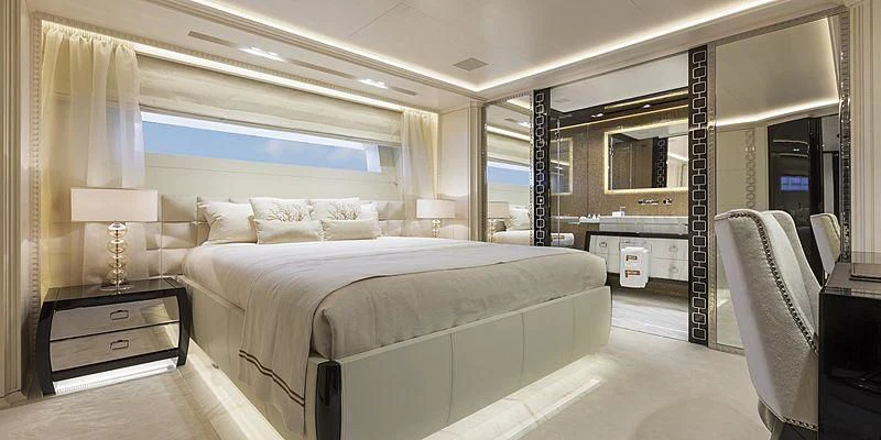 a room with a bed and a desk aboard PARILLION Yacht for Sale