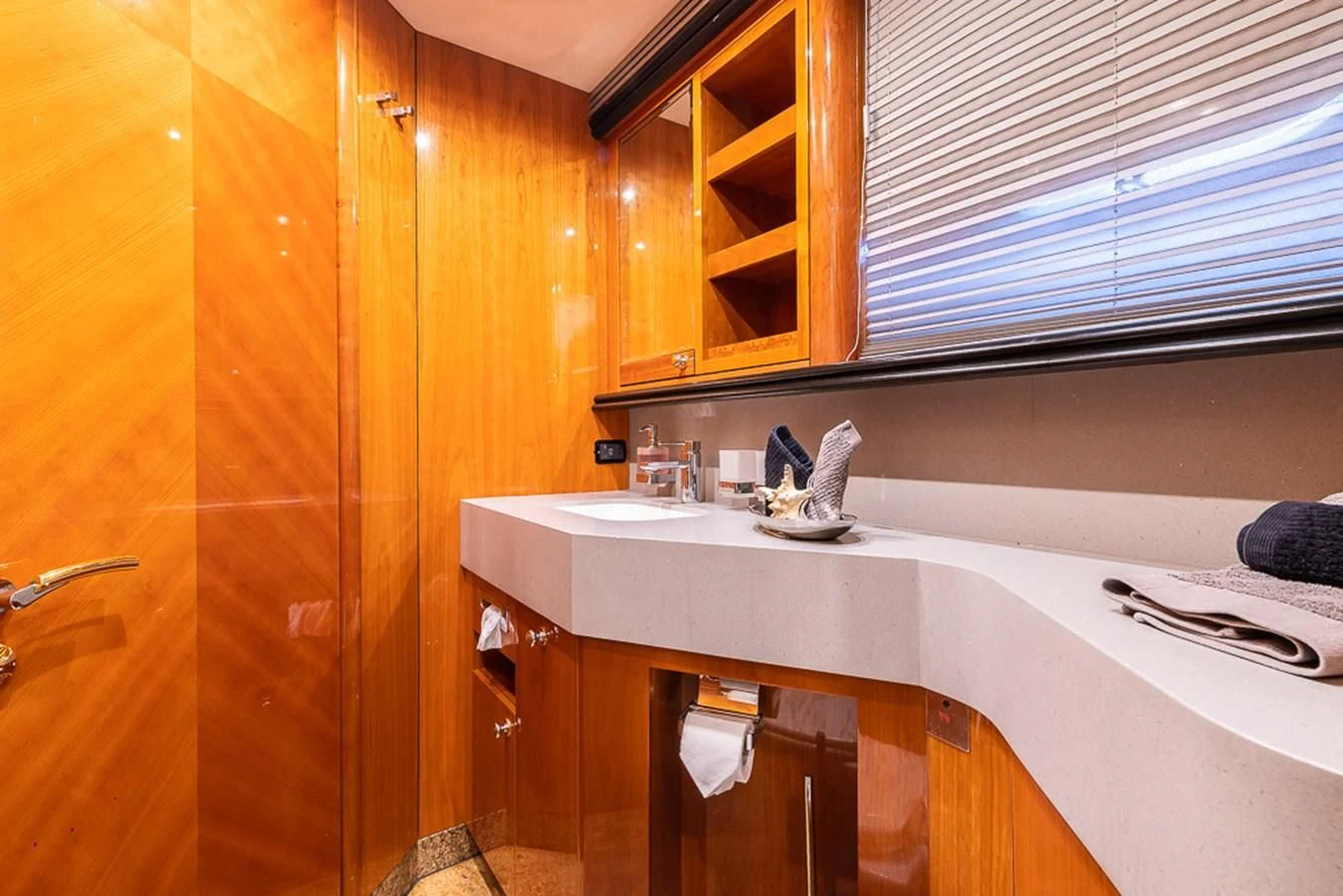 a bathroom with a sink and wooden cabinets aboard SMOOTH OPERATOR Yacht for Sale