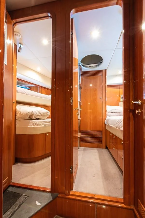 a bathroom with a wood door aboard SMOOTH OPERATOR Yacht for Sale
