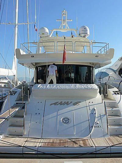 a large white boat with a person standing on the deck aboard ANN G Yacht for Sale