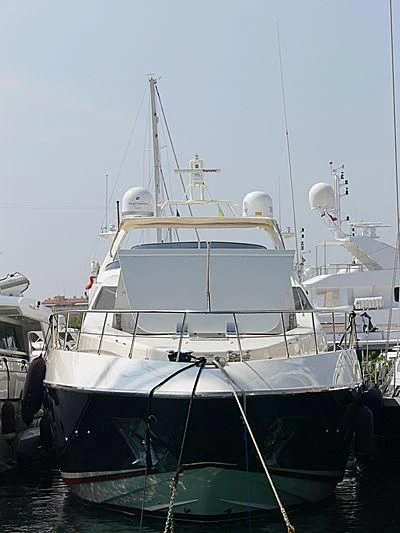 a white boat in a harbor aboard ANN G Yacht for Sale