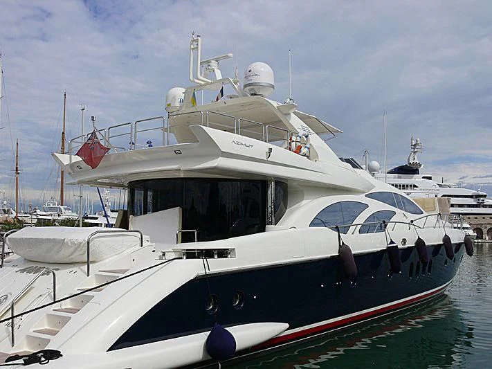 a white boat with red and blue sails aboard ANN G Yacht for Sale