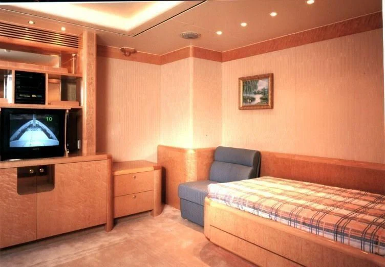 a bedroom with a bed and a tv aboard ATTESSA IV Yacht for Sale