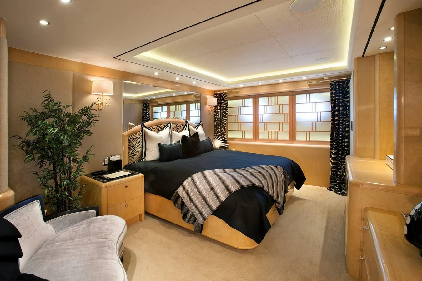 a bedroom with a bed and a desk aboard ATTESSA IV Yacht for Sale