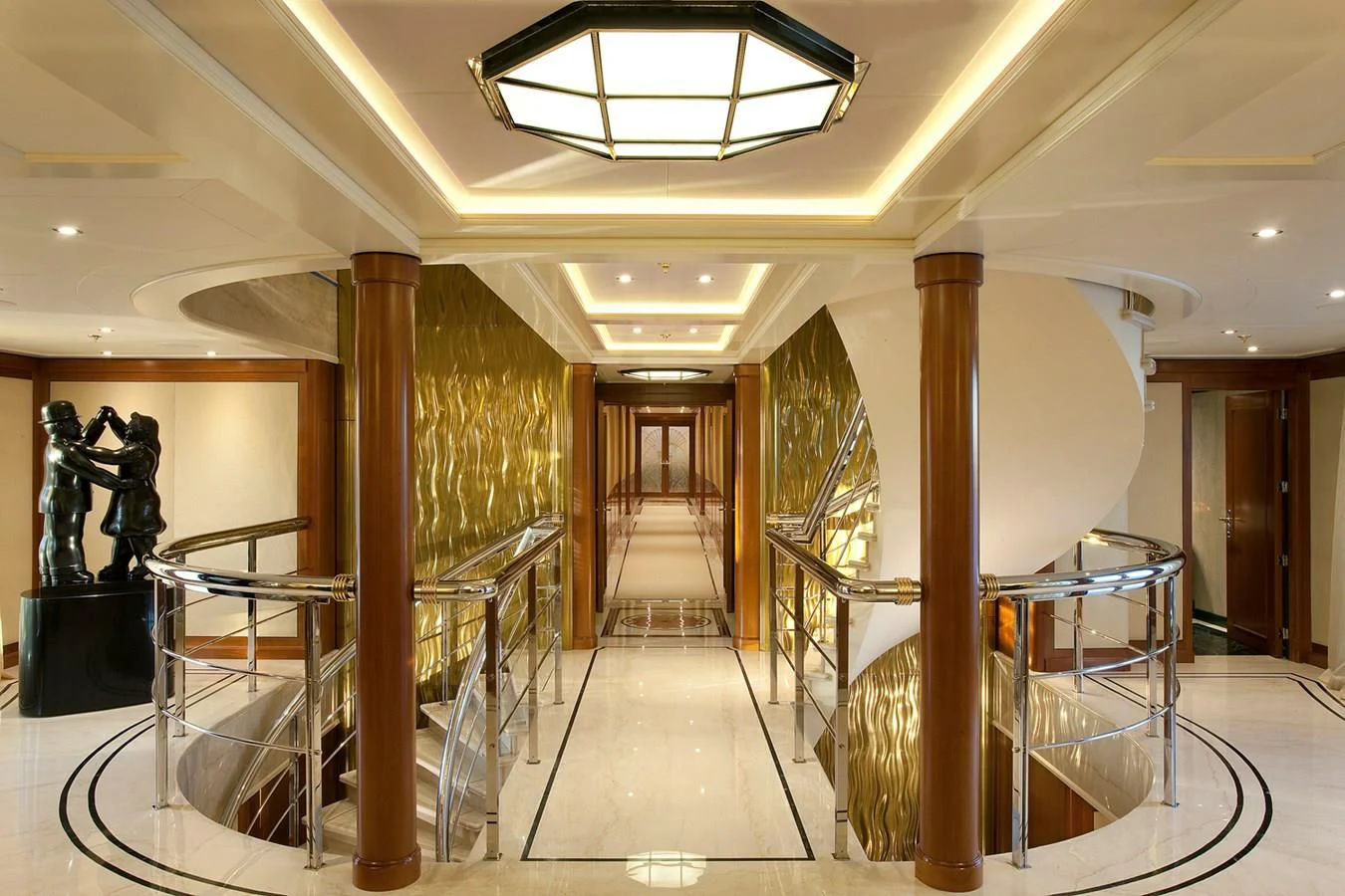 a large room with a staircase and a chandelier aboard ATTESSA IV Yacht for Sale