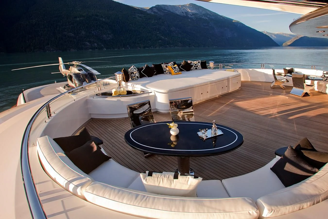 a large swimming pool with a table and chairs on it aboard ATTESSA IV Yacht for Sale