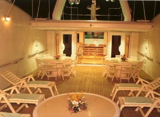 a room with tables and chairs aboard ATTESSA IV Yacht for Sale