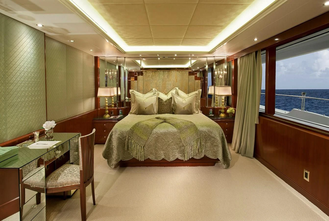 a bedroom with a bed and a table aboard ATTESSA IV Yacht for Sale