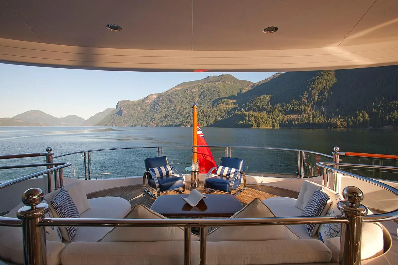a table with chairs and a fire on it by a body of water aboard ATTESSA IV Yacht for Sale