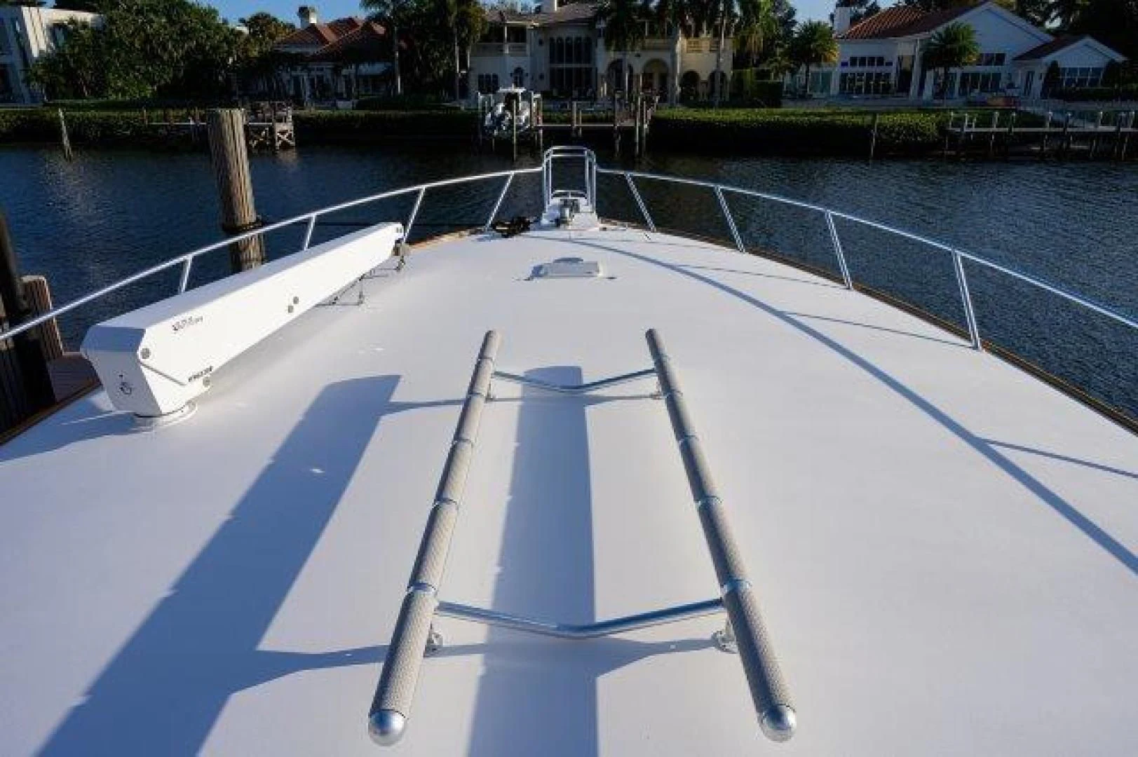 a pool with a deck and houses in the background aboard LITTLE AUDREY Yacht for Sale