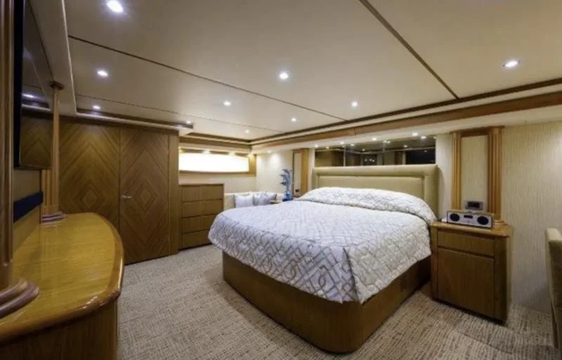 a bedroom with a bed and a desk aboard LITTLE AUDREY Yacht for Sale