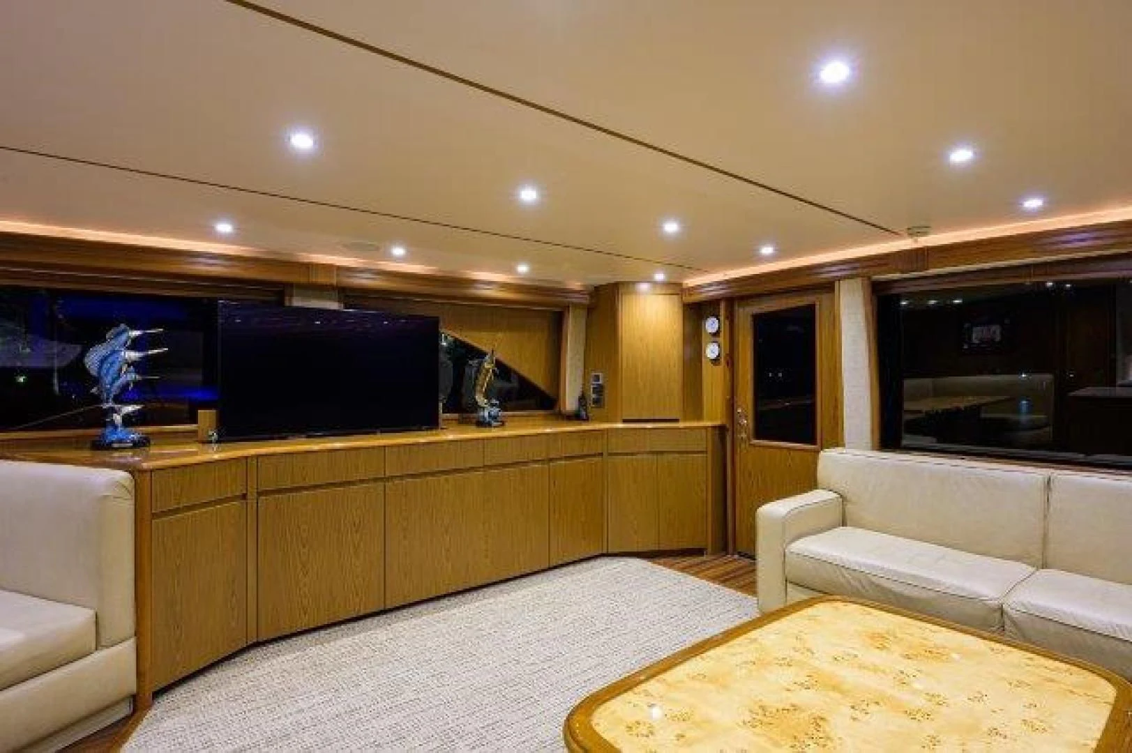 a room with a tv and couches aboard LITTLE AUDREY Yacht for Sale
