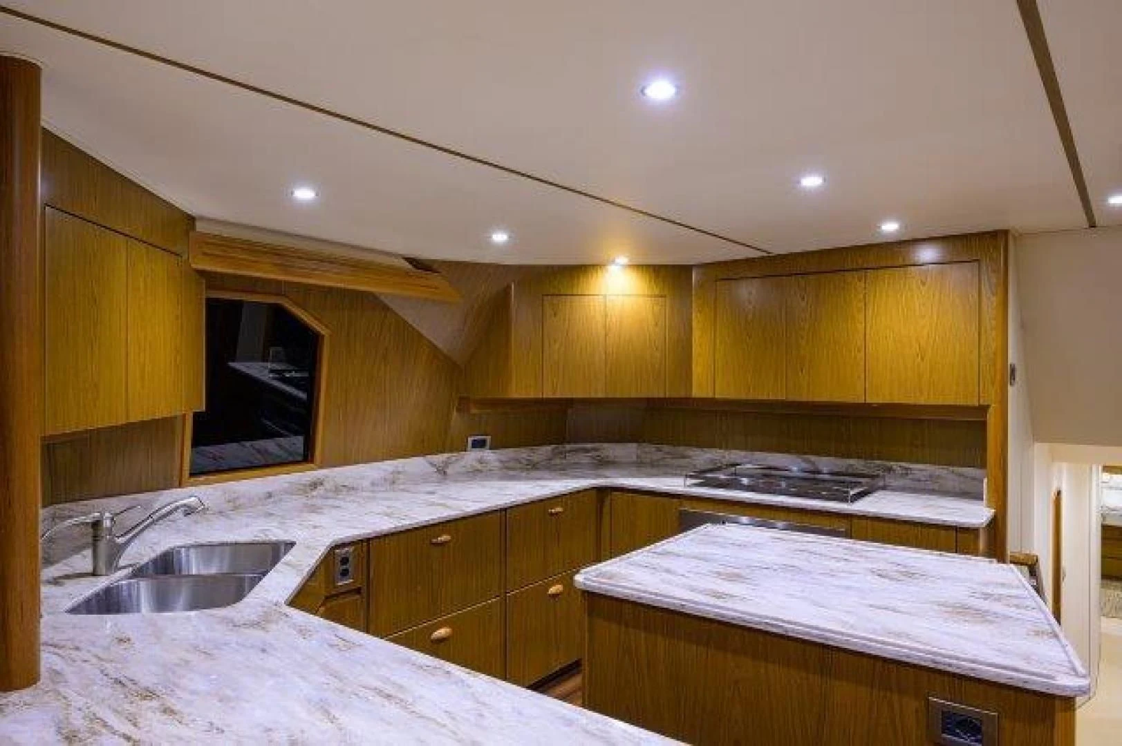 a kitchen with wooden cabinets aboard LITTLE AUDREY Yacht for Sale