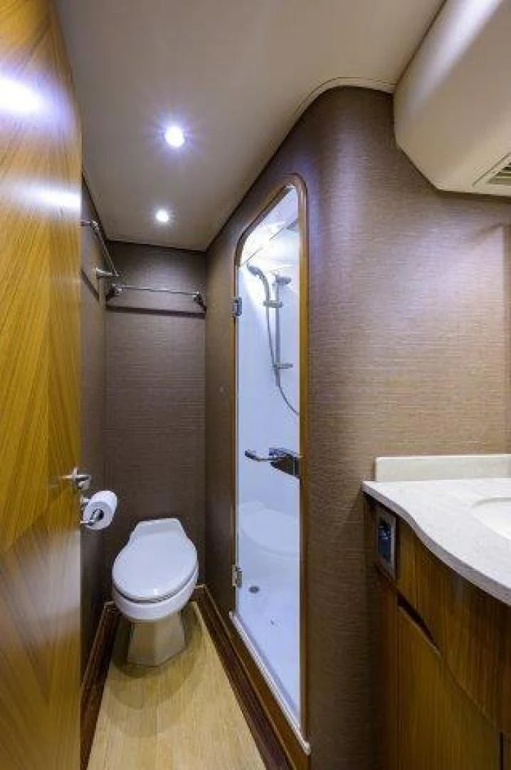 a bathroom with a toilet and a sink aboard LITTLE AUDREY Yacht for Sale