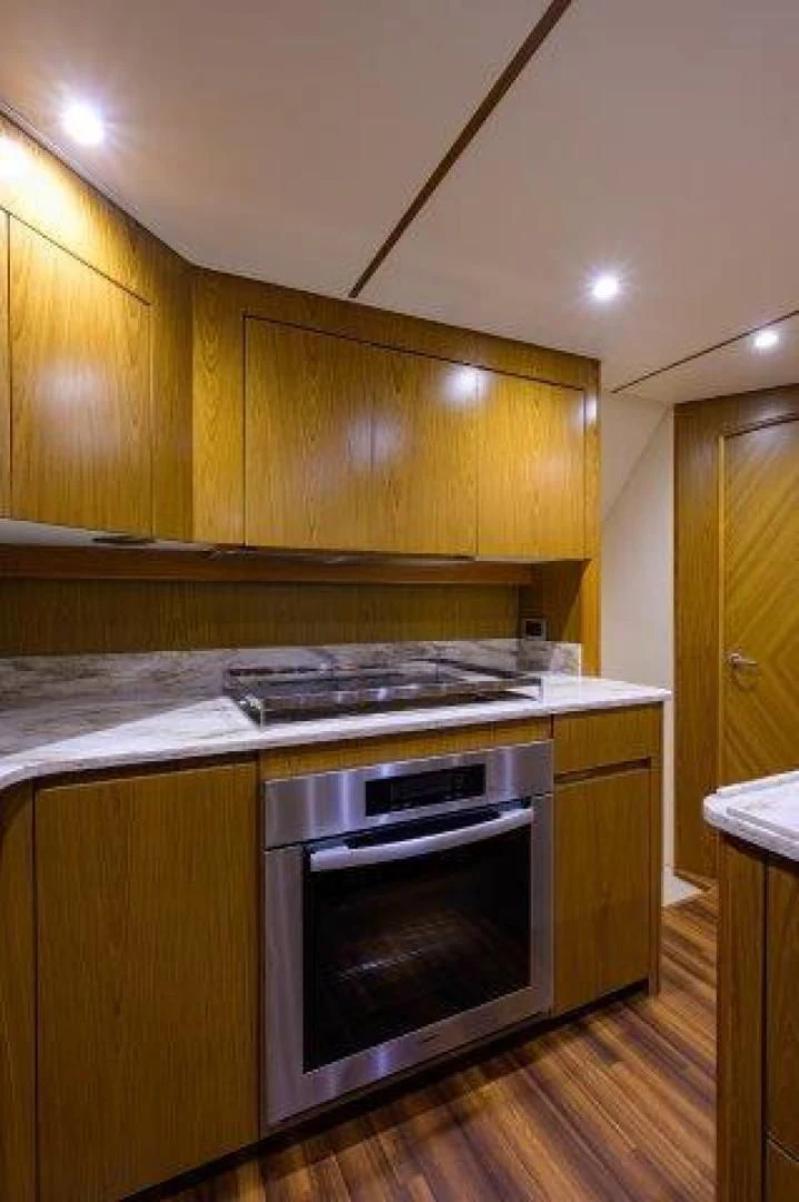 a kitchen with wooden cabinets aboard LITTLE AUDREY Yacht for Sale