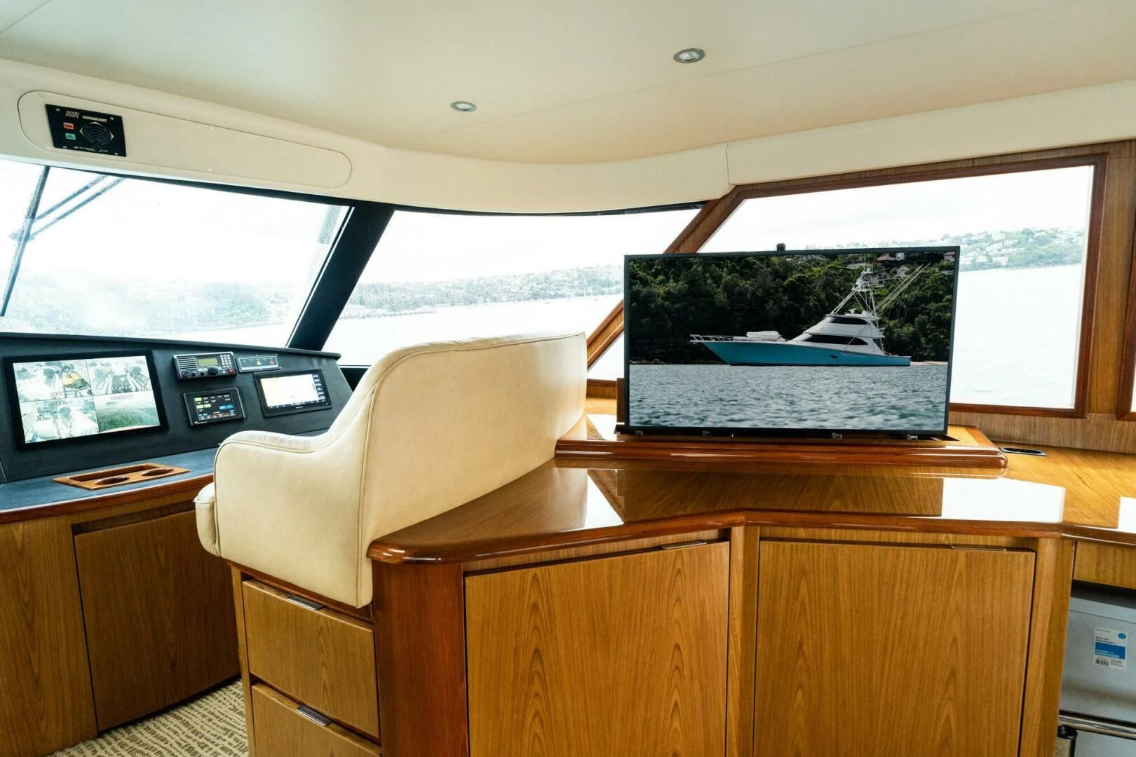 a room with a large window and a large television on the wall aboard LITTLE AUDREY Yacht for Sale
