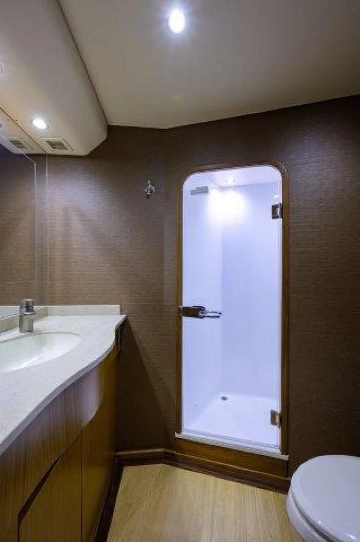 a bathroom with a glass door aboard LITTLE AUDREY Yacht for Sale
