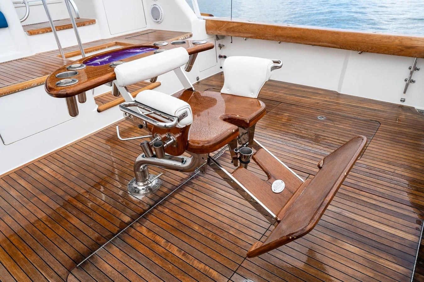 a wooden chair with a table and chairs on it aboard LITTLE AUDREY Yacht for Sale