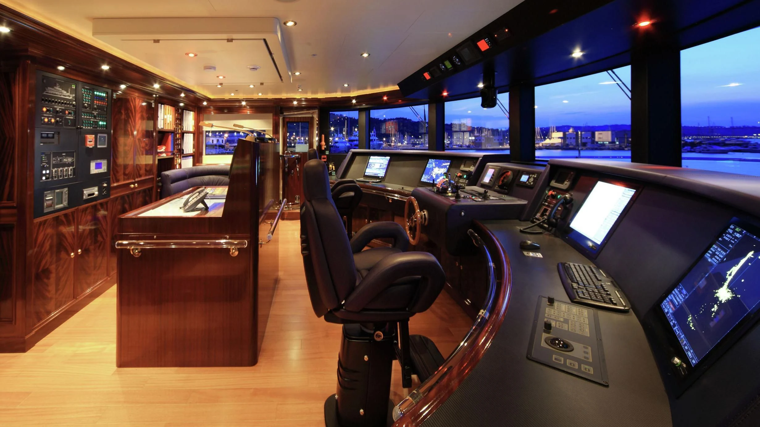 a room with a row of computer screens and a wood cabinet aboard BEOL Yacht for Sale