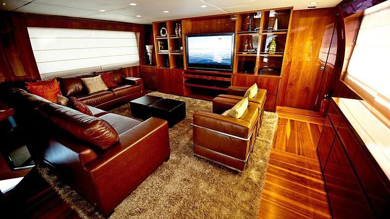 a living room with leather couches aboard ZENITH Yacht for Sale