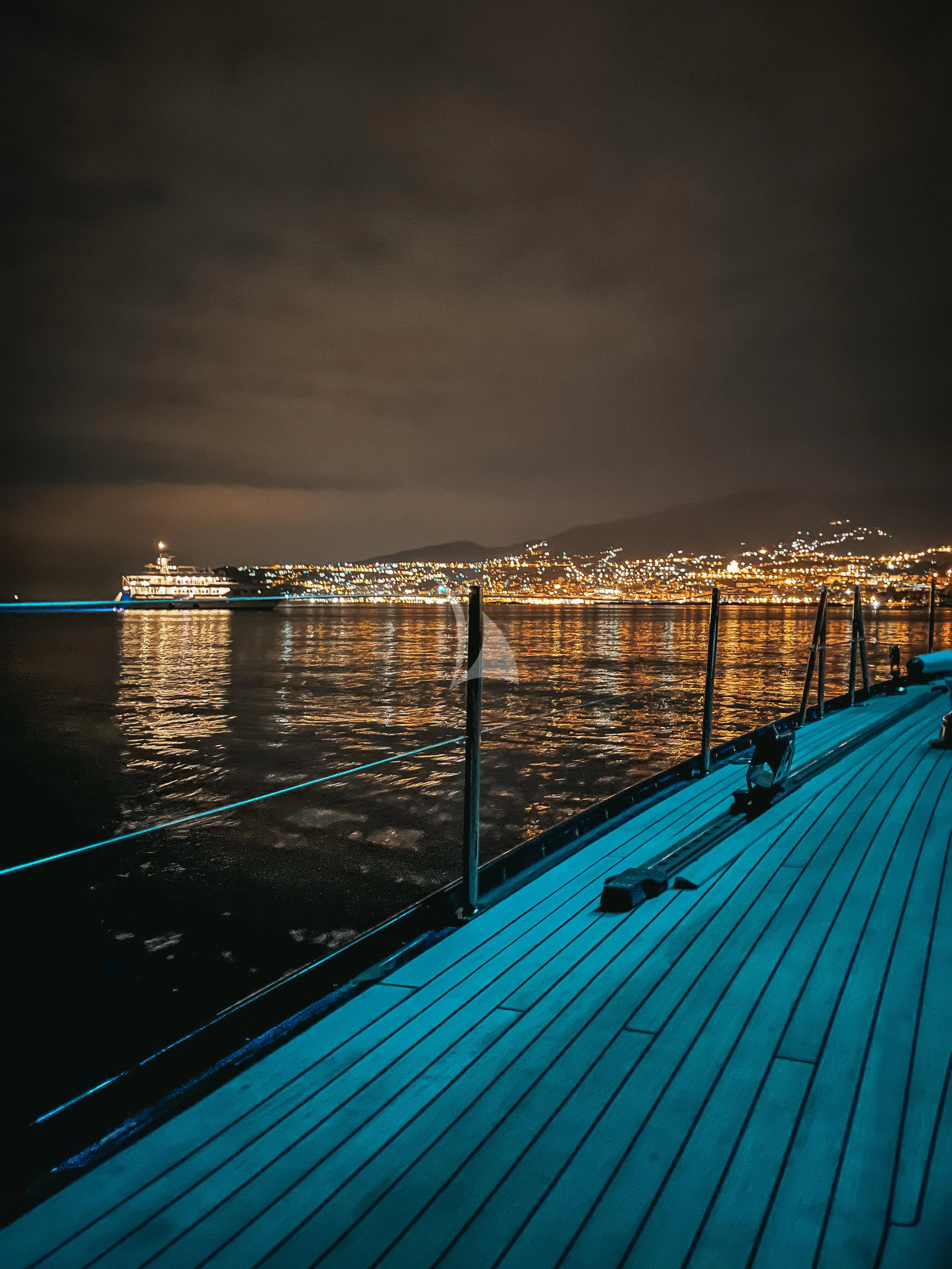 a dock with a city in the background aboard DARK STAR OF LONDON Yacht for Charter