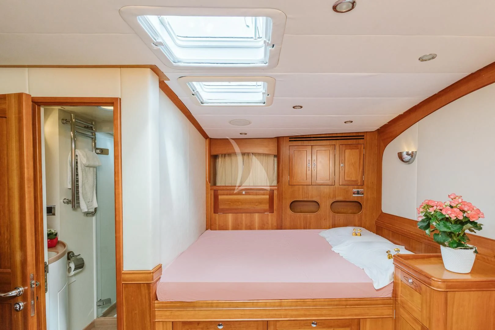 a bedroom with a bed and a mirror aboard DARK STAR OF LONDON Yacht for Charter