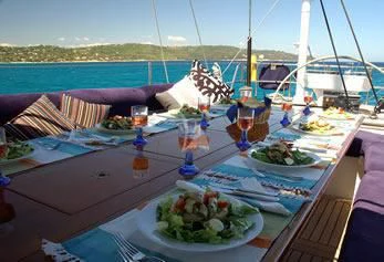 a table with food and drinks on it aboard DARK STAR OF LONDON Yacht for Charter