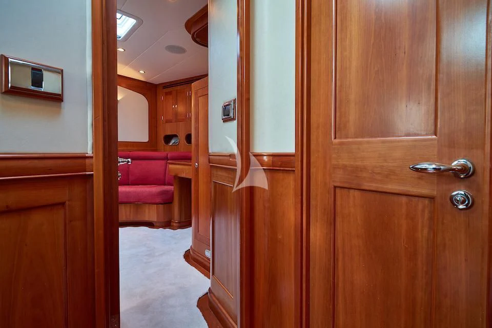 a room with a wood door and a mirror aboard DARK STAR OF LONDON Yacht for Charter