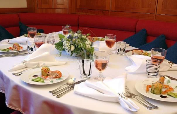 a table with plates of food and glasses on it aboard DARK STAR OF LONDON Yacht for Charter