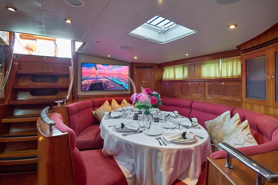 a dining room with a table and chairs aboard DARK STAR OF LONDON Yacht for Charter
