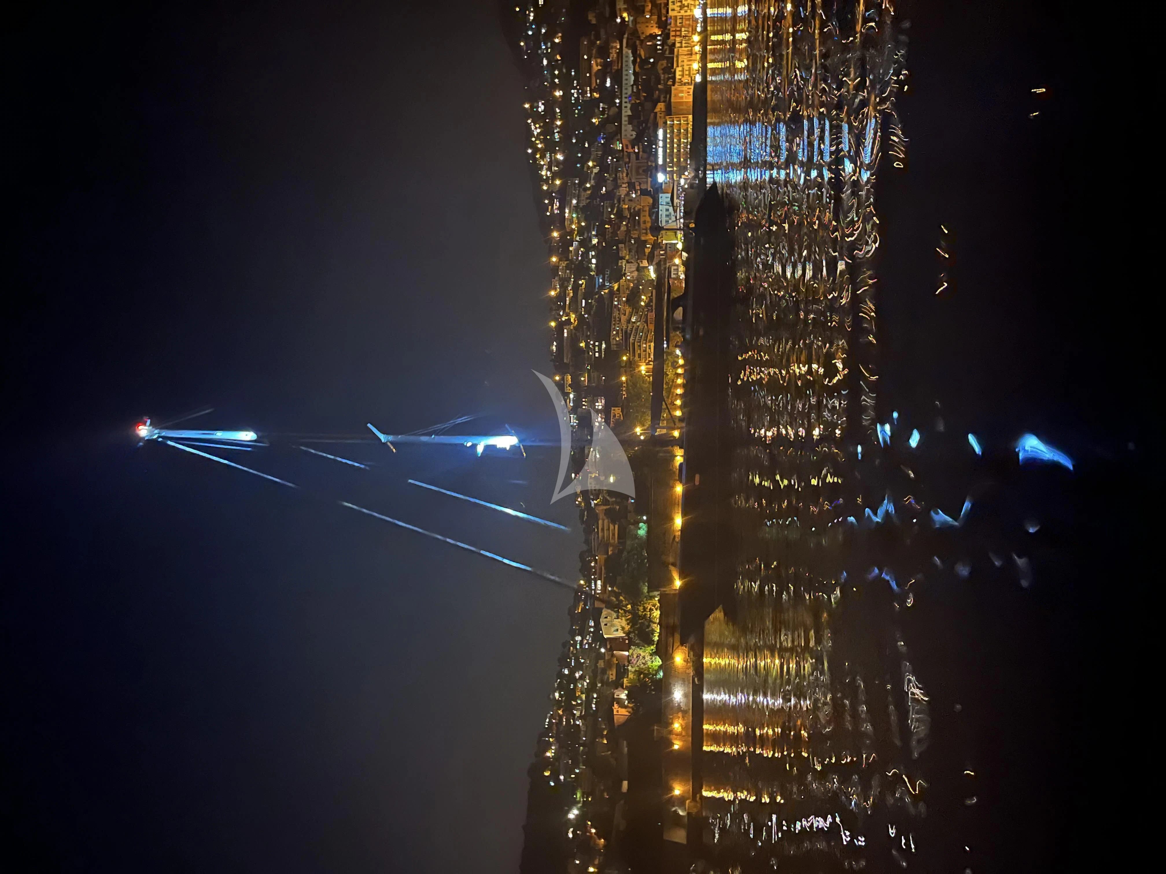 a city at night aboard DARK STAR OF LONDON Yacht for Charter