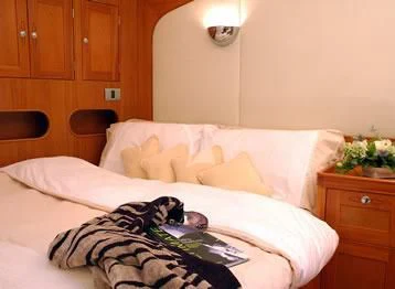 a person lying on a bed aboard DARK STAR OF LONDON Yacht for Charter