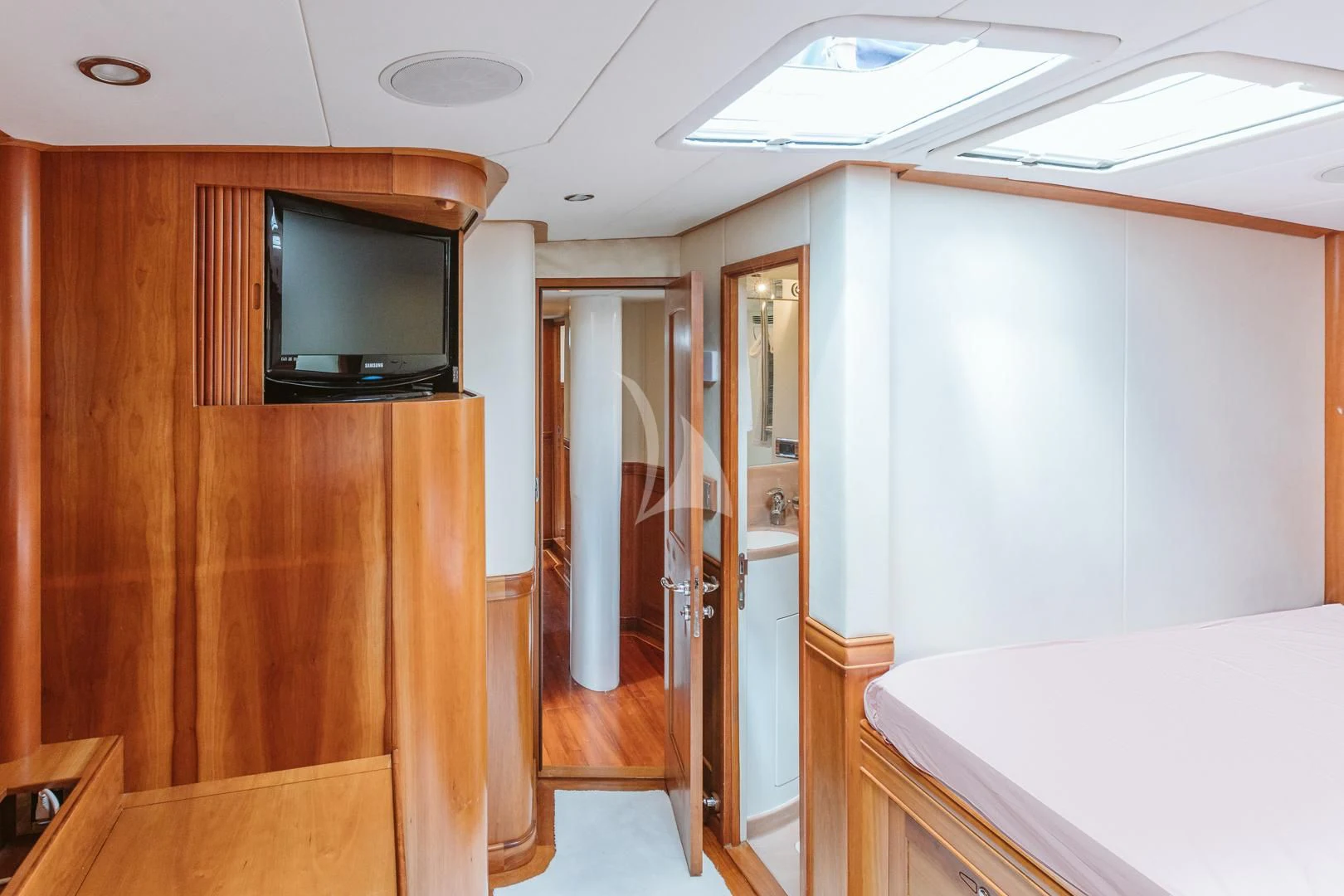 a room with a tv and a bed aboard DARK STAR OF LONDON Yacht for Charter