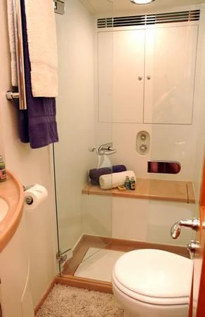 a bathroom with a toilet and a sink aboard DARK STAR OF LONDON Yacht for Charter