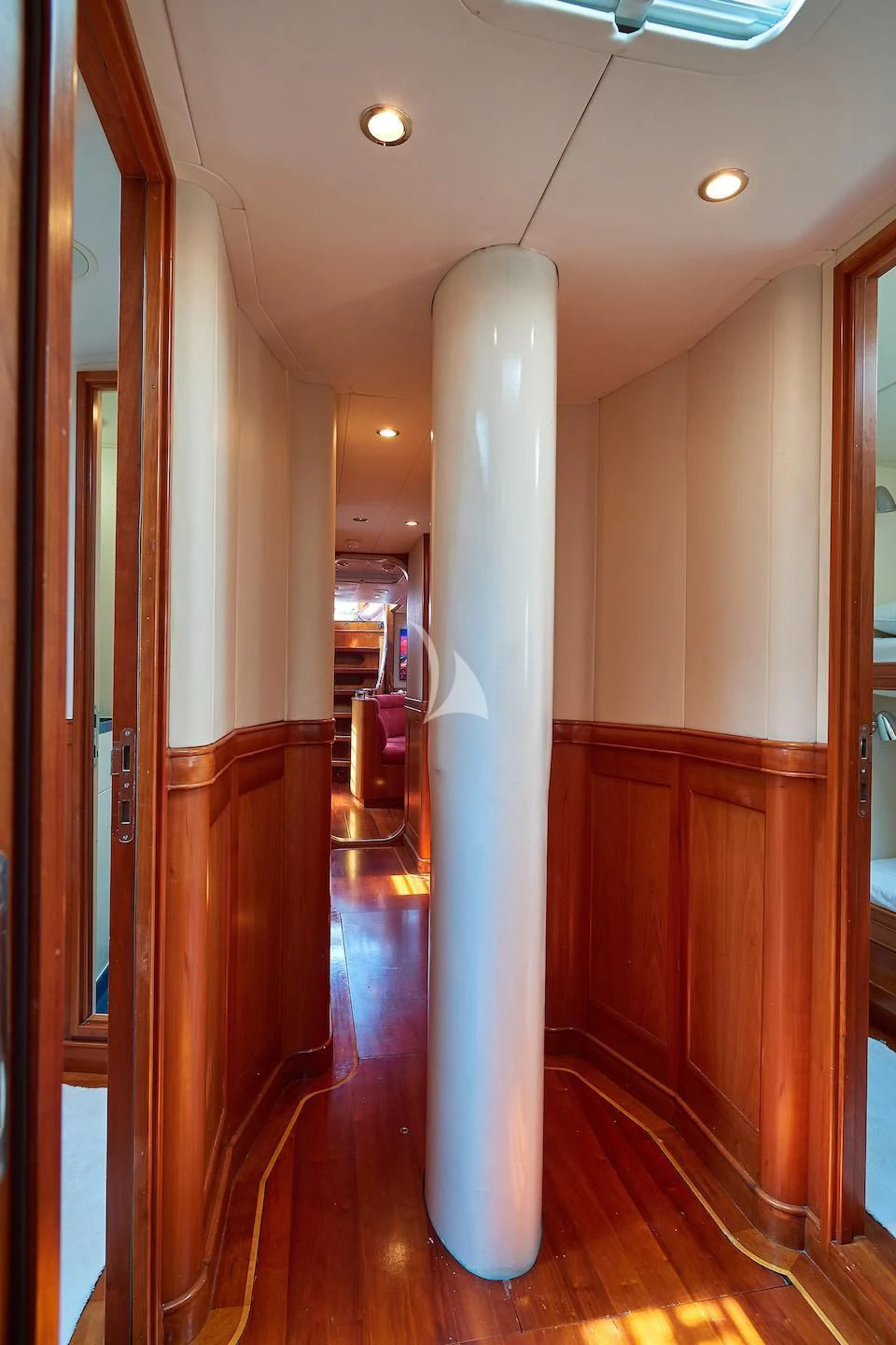 a hallway with a white column aboard DARK STAR OF LONDON Yacht for Charter
