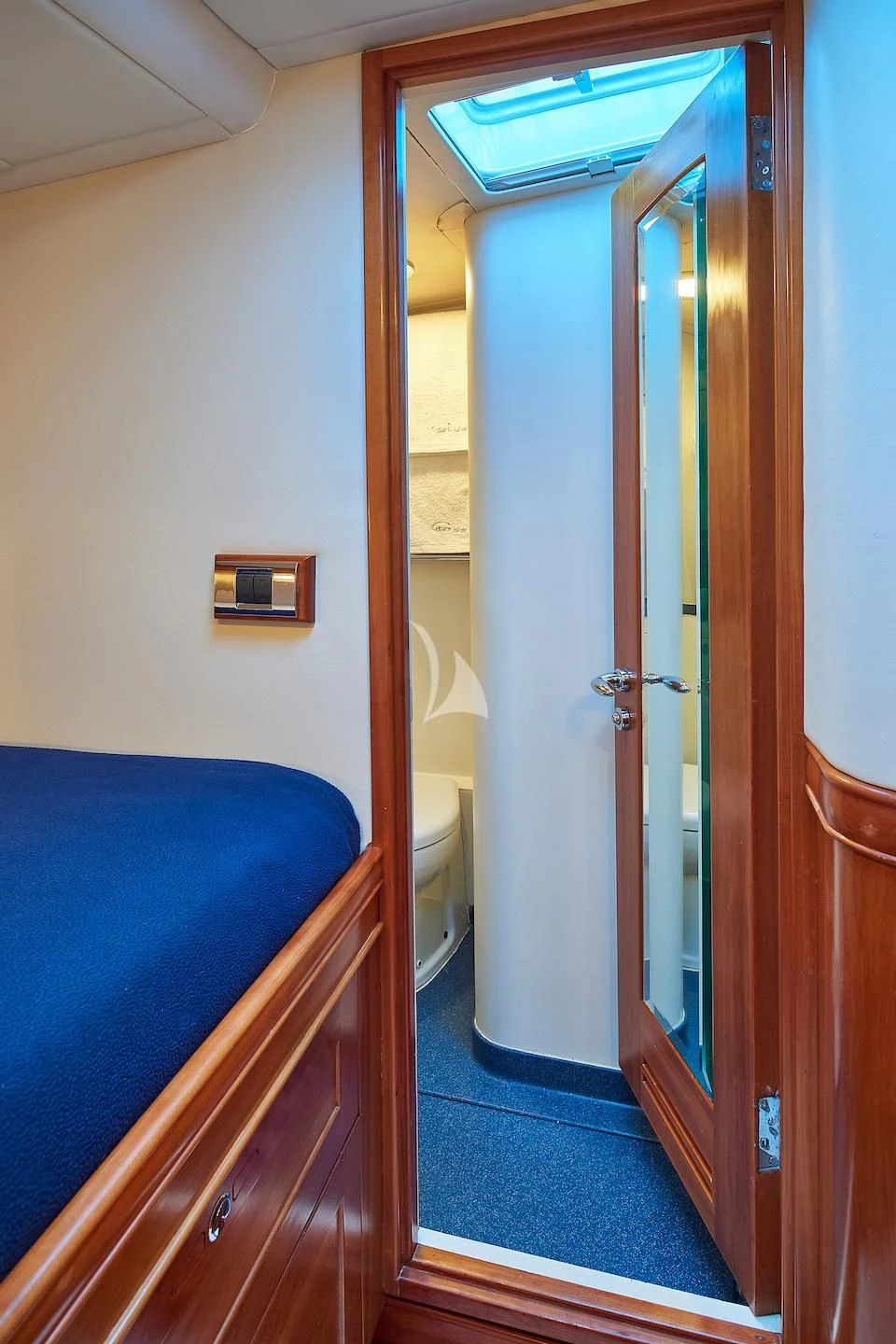 a bathroom with a blue bed aboard DARK STAR OF LONDON Yacht for Charter