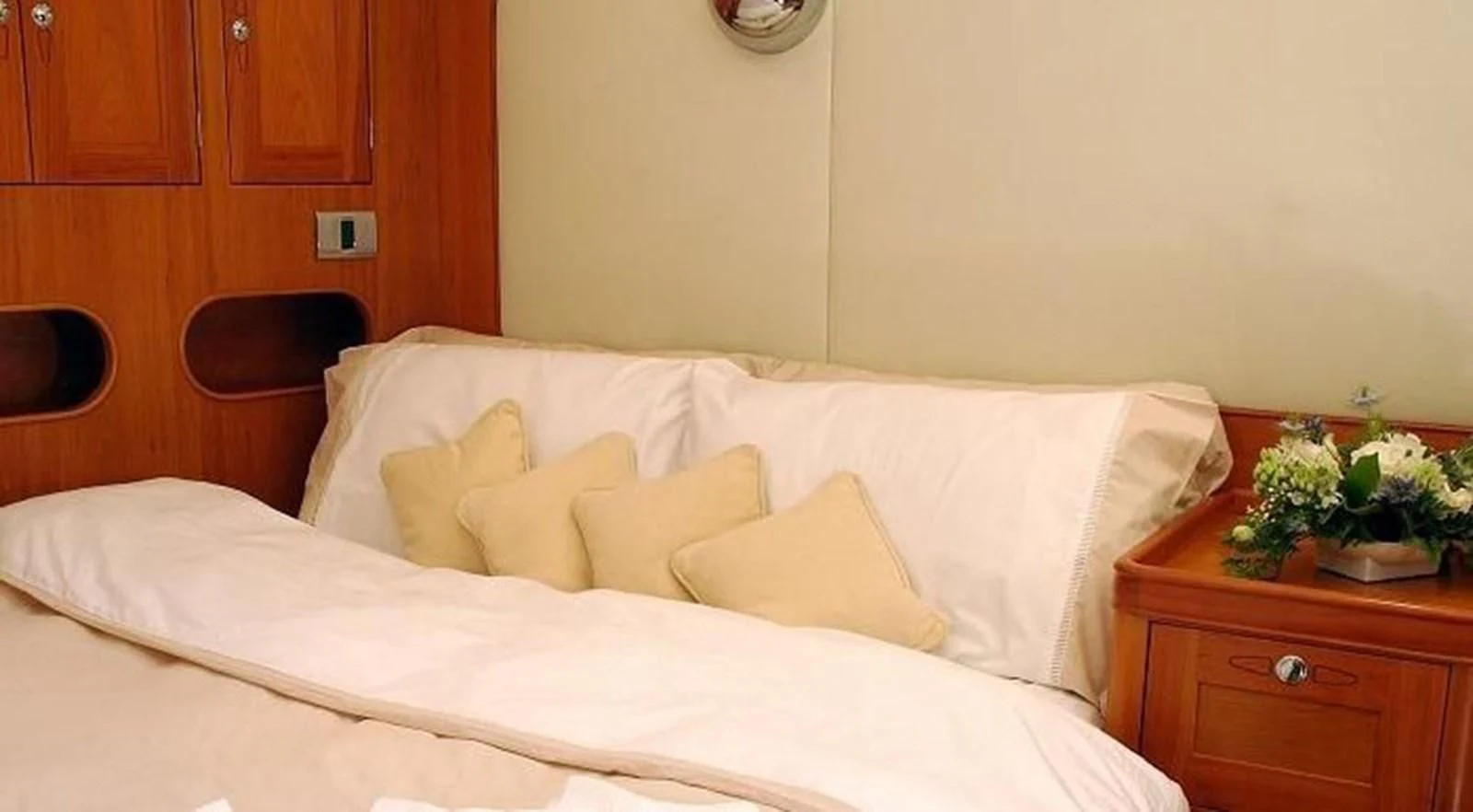 a bed with white sheets aboard DARK STAR OF LONDON Yacht for Charter