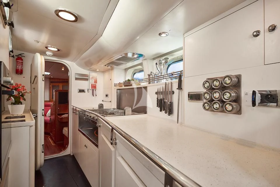 a kitchen with white cabinets aboard DARK STAR OF LONDON Yacht for Charter