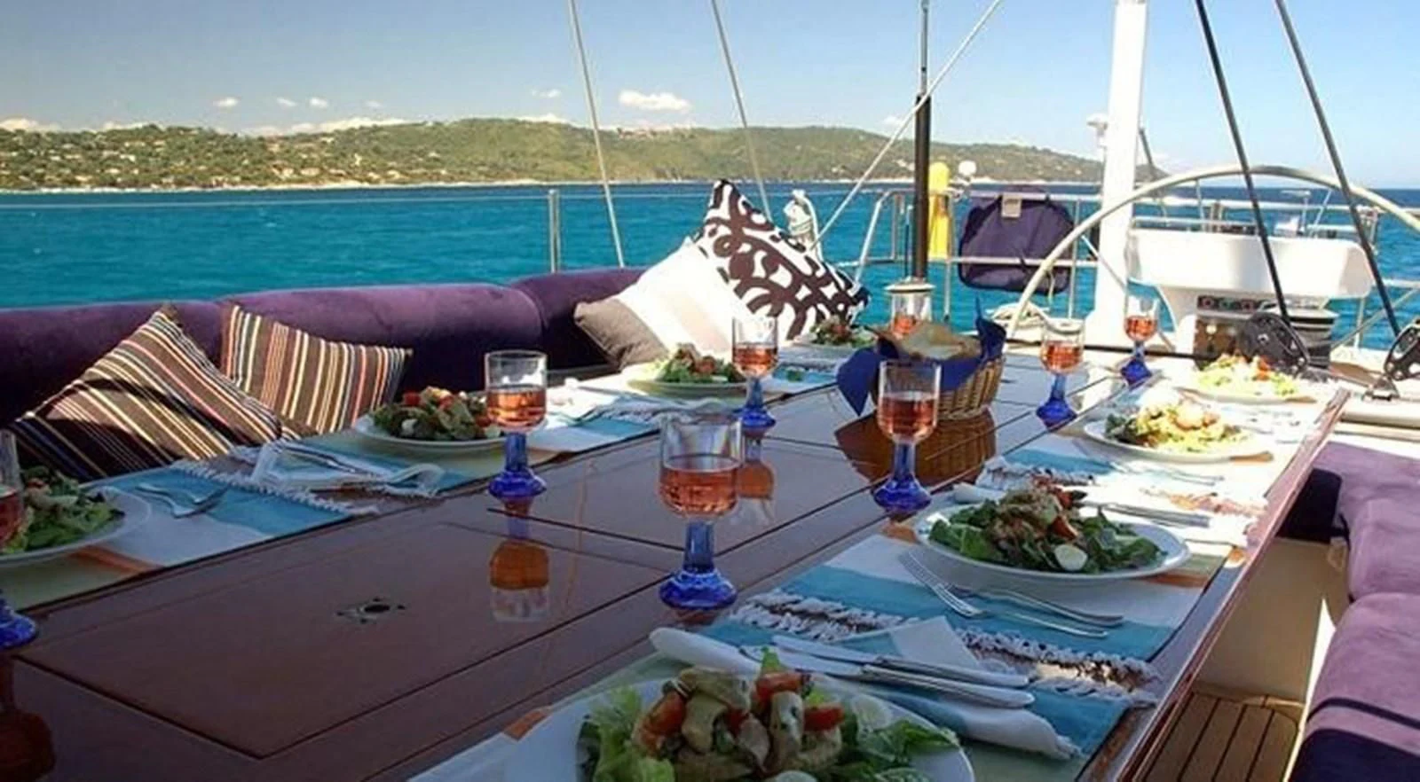 a table with food and drinks on it aboard DARK STAR OF LONDON Yacht for Charter