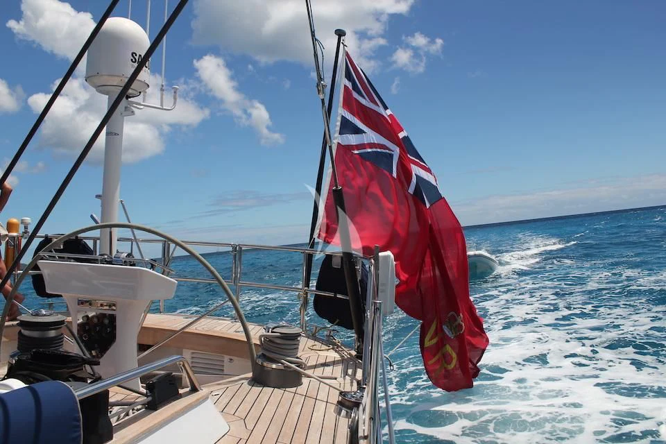 a boat with a flag on it aboard DARK STAR OF LONDON Yacht for Charter