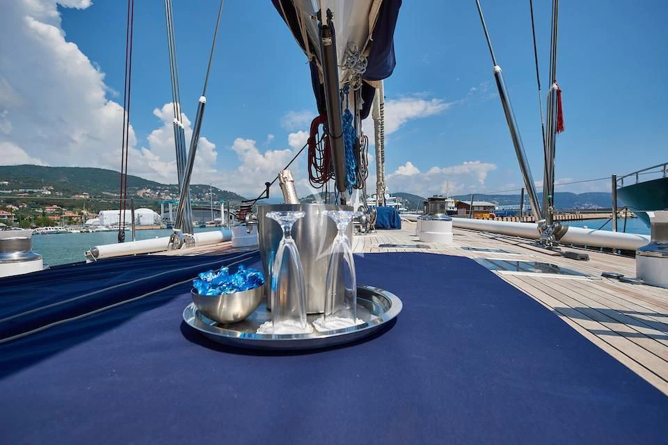 a fountain with blue water and boats in the background aboard DARK STAR OF LONDON Yacht for Charter