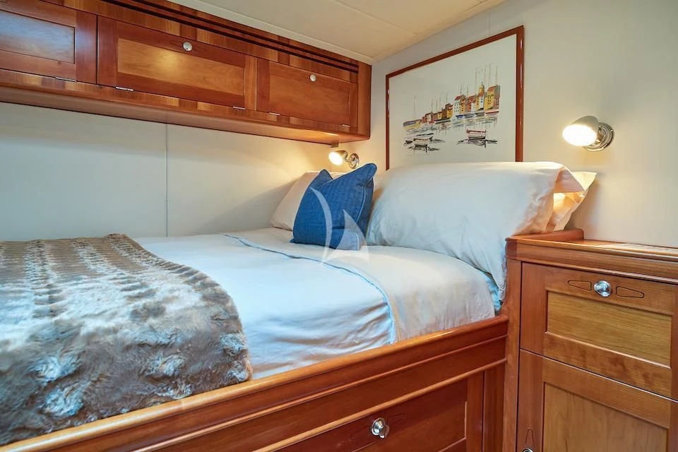 a bed with white sheets aboard DARK STAR OF LONDON Yacht for Charter