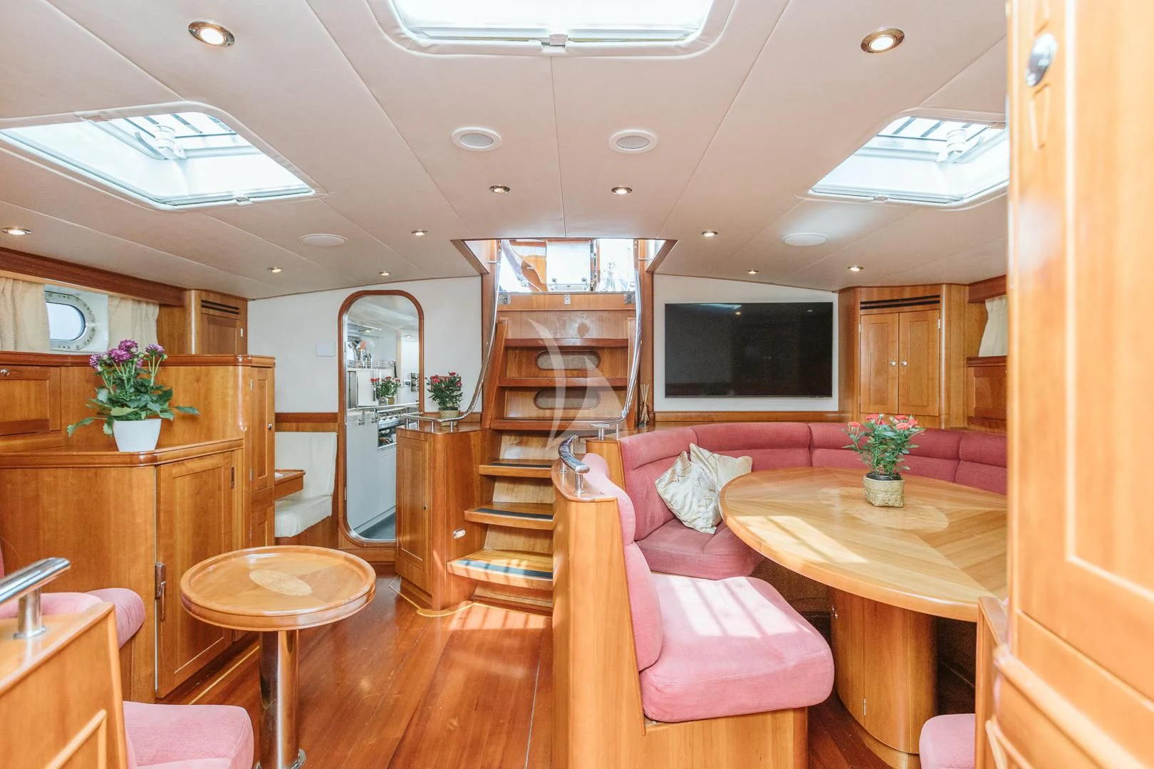 a living room with a wood floor aboard DARK STAR OF LONDON Yacht for Charter