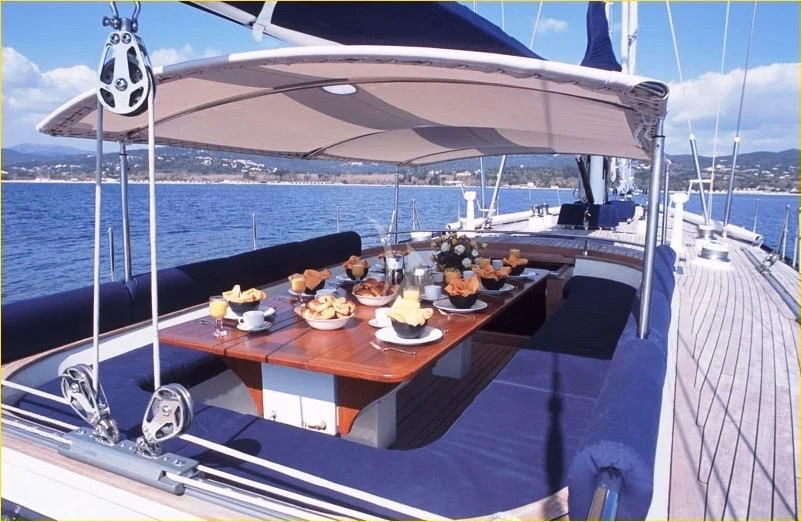 a table with food on it aboard DARK STAR OF LONDON Yacht for Charter