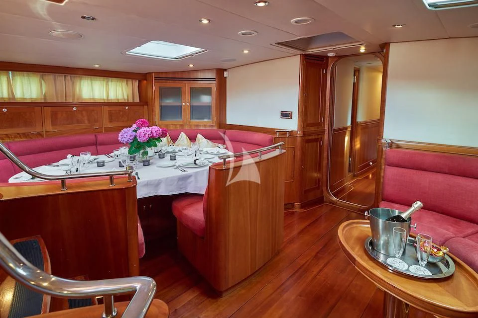 a kitchen with a table and chairs aboard DARK STAR OF LONDON Yacht for Charter