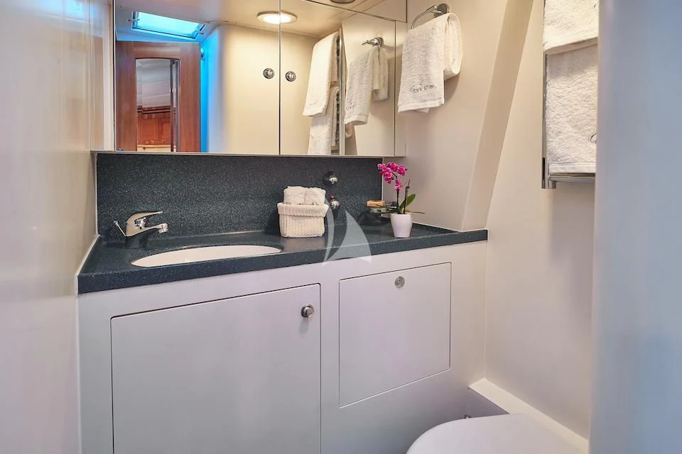 a bathroom with a sink and a mirror aboard DARK STAR OF LONDON Yacht for Charter