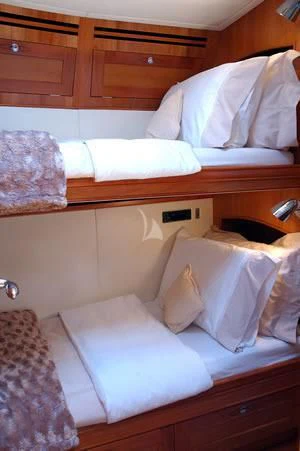 a bed with pillows aboard DARK STAR OF LONDON Yacht for Charter